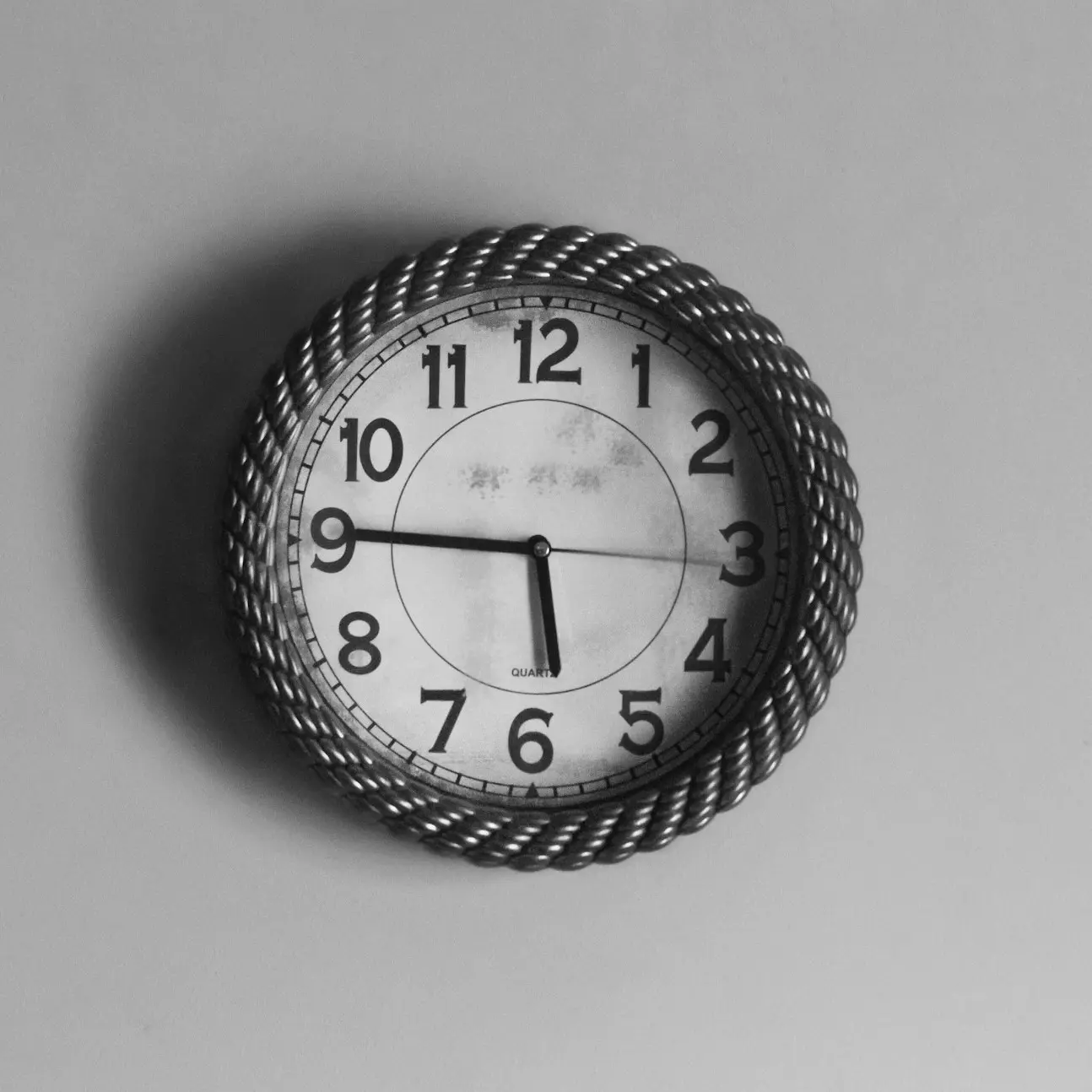 black and white analog wall clock at 10 10