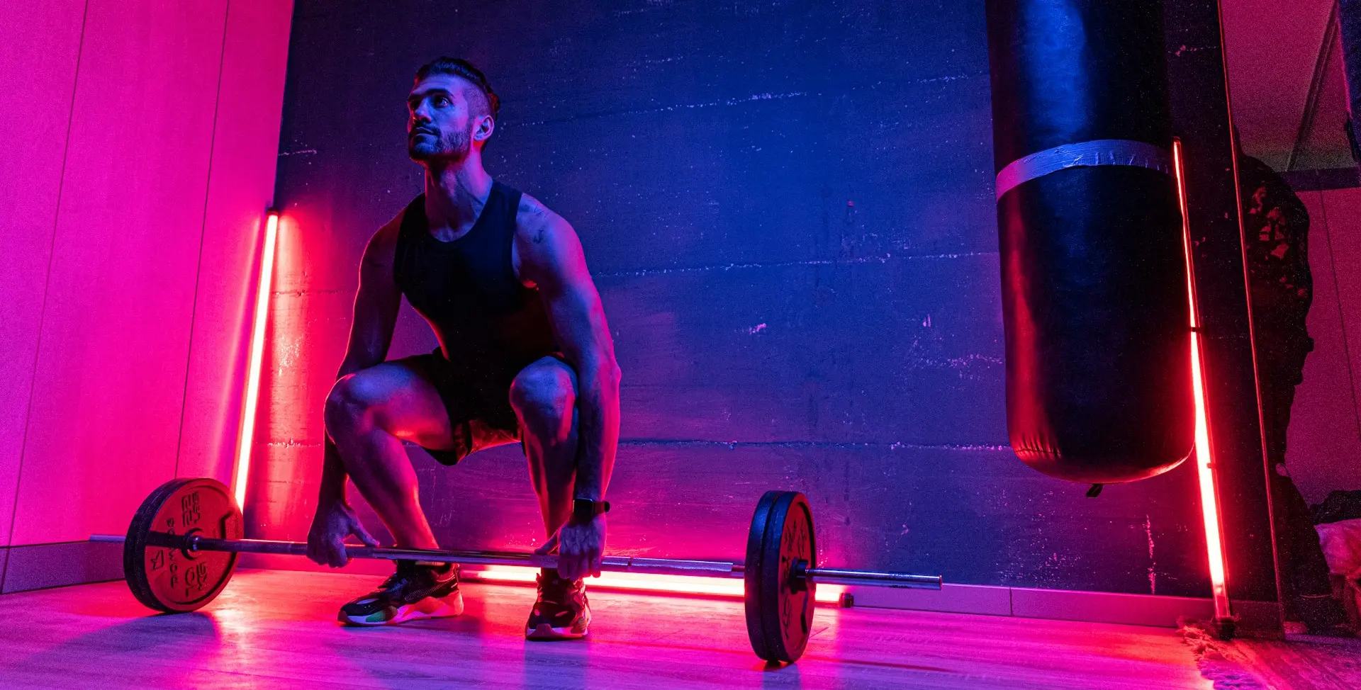 man in black tank top and blue shorts doing exercise